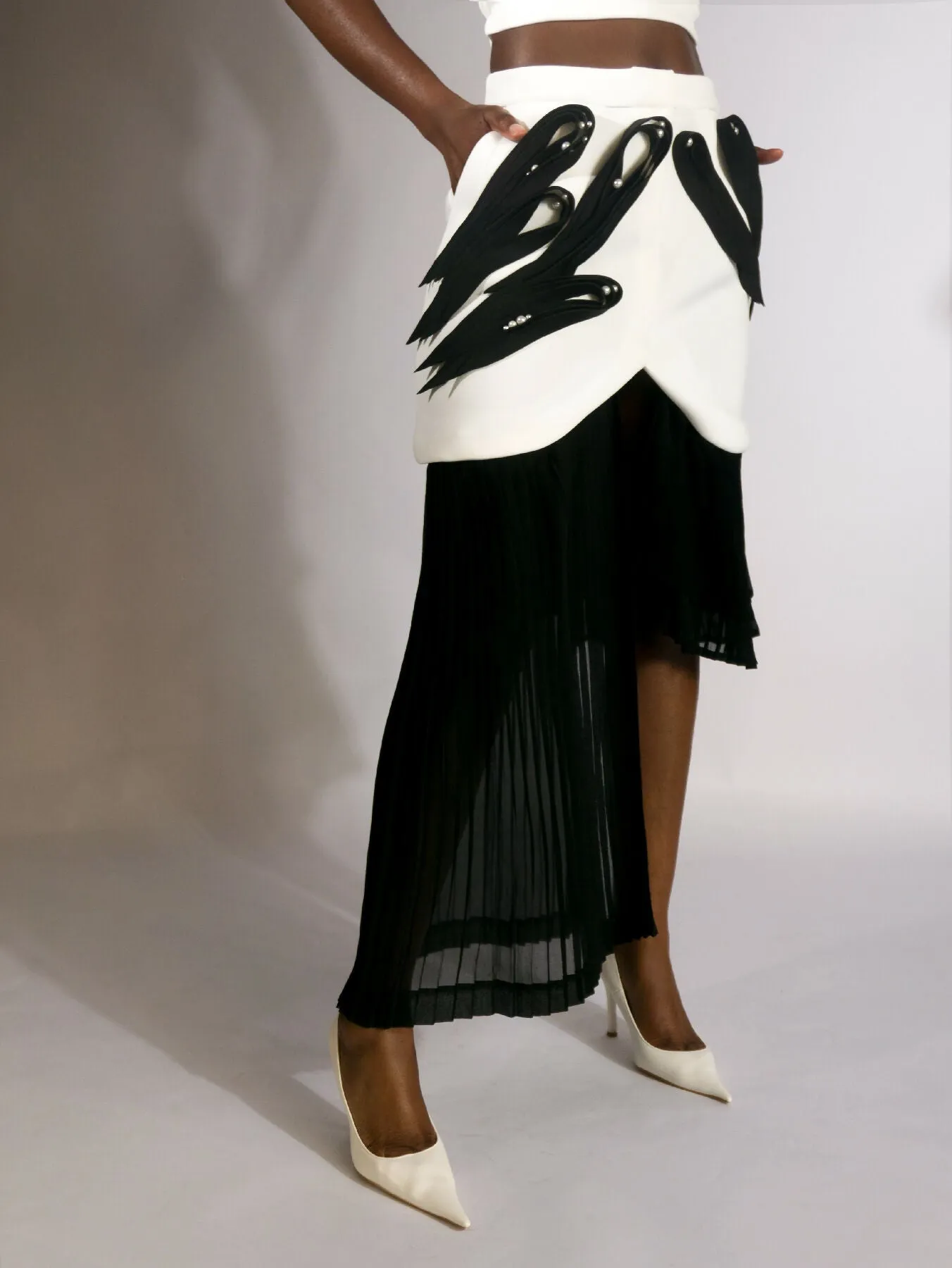 ARGO, asymmetrical pleated skirt with neoprene quilling-like application