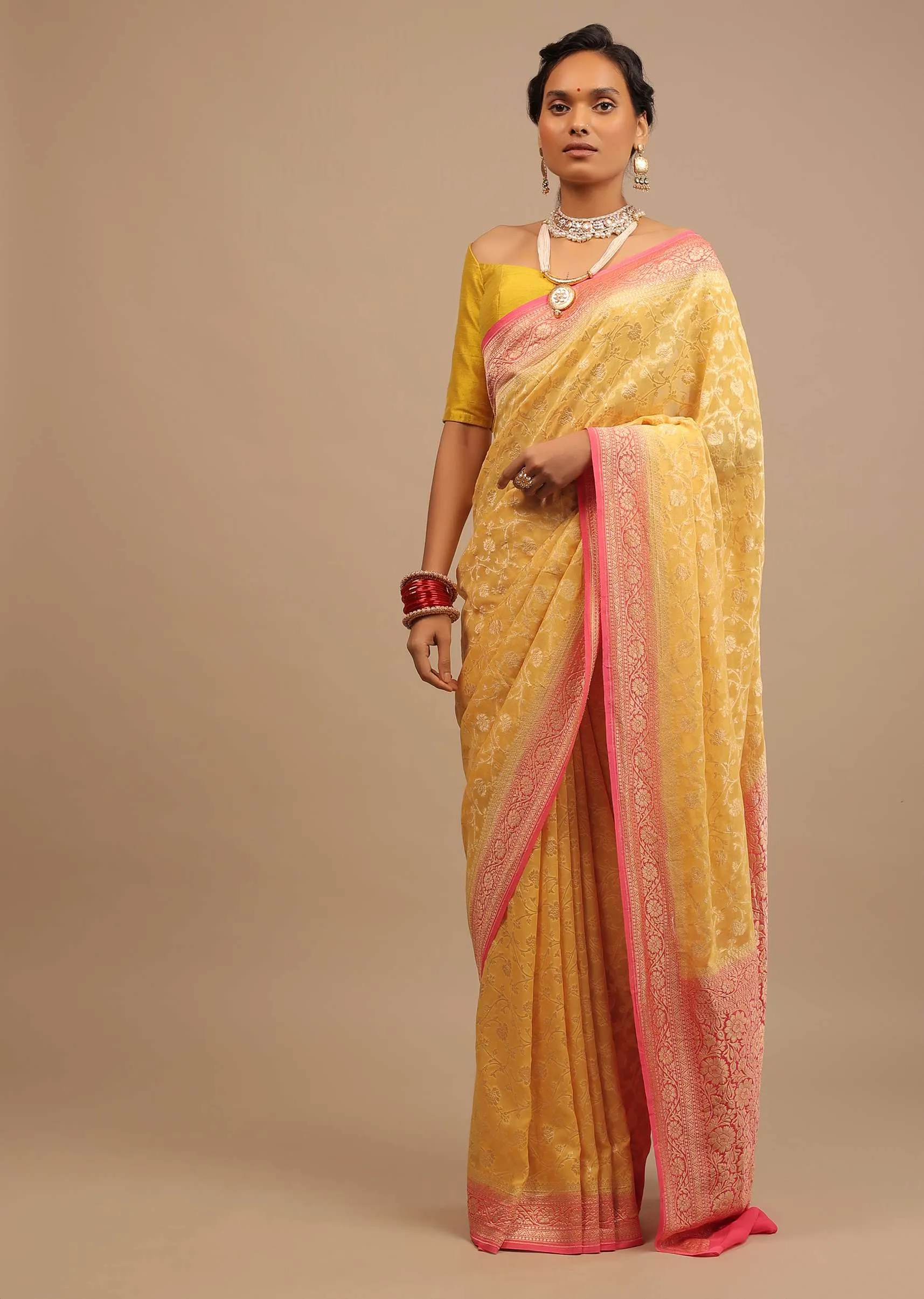 Canary Yellow Traditional Georgette Saree With Contrasting Peach Brocade Border And Jaal Work